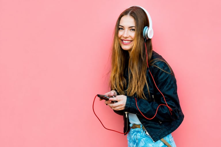 Young woman wearing headphones smiling and relaxed